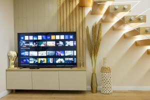 a flat screen tv sitting on top of a cabinet at Arial Lofts in Vlorë