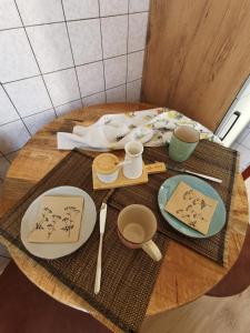 a table with plates and utensils on top of it at Ferienwohnung Ostsee in Karby +2 photos