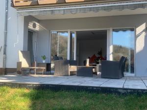 a group of chairs sitting on a patio at Ferien- & Wellneswohnung mit privater Sauna und Whirlpool in Gelnhausen