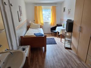 a small room with a bed and a sink and a bathroom at Haus Hoogendam in Leoben +45 photos