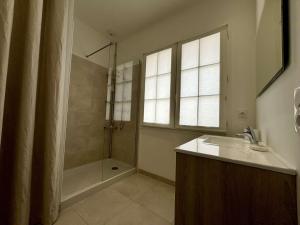 a bathroom with a shower and a sink and a shower at Maison 4 pièces 6 couchages Saint Denis d'Oléron SDO000-609 in Saint-Denis-dʼOléron +3 photos