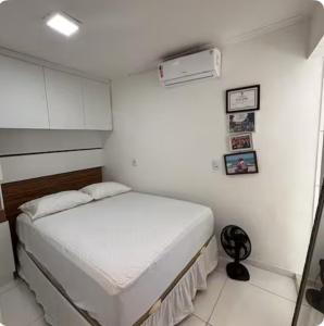 a small white bedroom with a bed in it at Casa de Praia na Barra, Ilhéus in Ilhéus