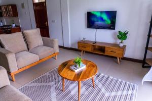 a living room with a couch and a coffee table at Timeless Stays in Arusha