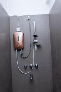 a shower in a bathroom with a soap dispenser at Timeless Stays in Arusha