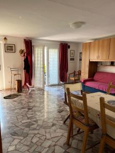 a living room with a bed and a table and chairs at Orchidea in Viareggio