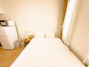 Postel nebo postele na pokoji v ubytování ホテル サンフェリシアン京都四条烏丸