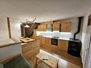 a kitchen with wooden cabinets and a stove at Sella Nevea Resort in Sella Nevea