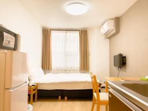Postel nebo postele na pokoji v ubytování ホテル サンフェリシアン京都四条烏丸