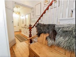 a room with a staircase with a rug on the floor at Rooms At Greystoke in Criccieth