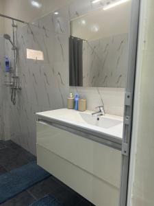 a white bathroom with a sink and a mirror at Appartement Somone , Sall Residence in Mbour +6 photos