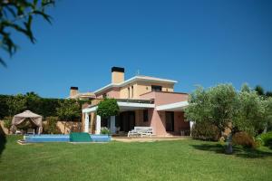 a house with a swimming pool in a yard at Sani Waterscape Villa in Sani Beach