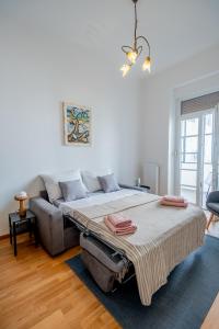 a bedroom with a large bed and a couch at Eta - apartman u centru grada in Pula