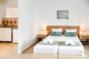 a bedroom with two beds and a kitchen at Secreta Vista in Kavos +75 photos