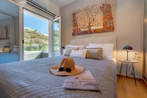 a hat on top of a bed in a bedroom at Semeli Art House 2 in EFL +54 photos