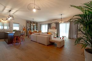 a living room with a couch and a table at Semeli Art House 2 in EFL