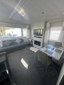 a living room with a couch and a table at Happy Hilda in Selsey