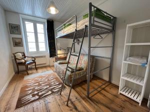 a room with two bunk beds and a chair at Mais 4 pièces Oléron 6 couchages SAINT GEORGES D'OLERON SGO000-607 in Saint-Georges-dʼOléron