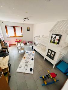 a room with two bunk beds and a table at Kinderparadies Alt Lüxem in Wittlich