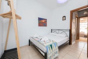 a bedroom with a bed and a ladder at Jella's sunny apartment in Nea Skioni