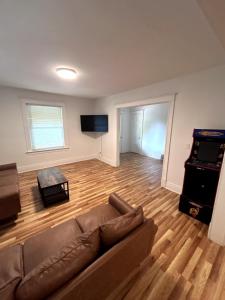 a living room with a couch and a video game at 6 bedroom House Short Walk to Niagara Falls in Niagara Falls