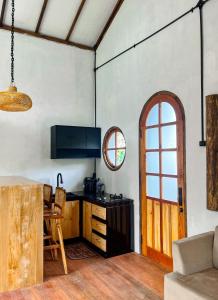 a room with a kitchen with a table and a door at Satha private villa Dieng 3 in Banjarnegara
