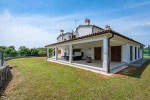 a house with a large yard in front of it at Holiday house Lera Rovinj, with football field, sauna, jacuzzi in Rovinj