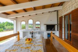a kitchen with a table with a bowl of fruit on it at Holiday house Lera Rovinj, with football field, sauna, jacuzzi in Rovinj