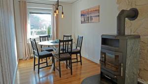 a living room with a table and a wood stove at Huus Günter in Tönning