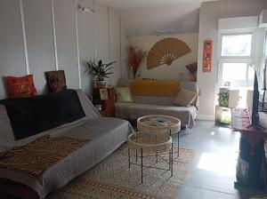 a living room with a couch and a table at Chez Dani in Château-du-Loir