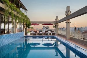 a swimming pool with a view of a building at Bronam Residence & Spa in Phumi Ta Phul