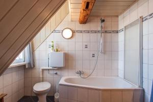 a bathroom with a tub and a toilet at Cosy & Historic Ambience in Markt Nordheim