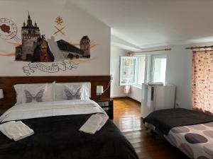 a bedroom with a large bed and a window at B&B Maria in Bucharest