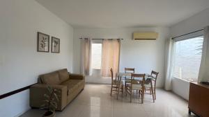 a living room with a couch and a table and chairs at Relax uno in Paysandú