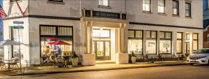 a store front of a building with tables and chairs at Hotel Audubon in Sainte Genevieve