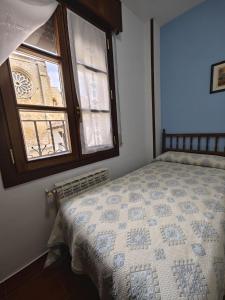 a bedroom with a bed and a window at Hostal las Cantigas in Villalcázar de Sirga +19 photos
