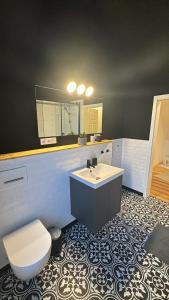 a bathroom with a sink and a toilet and a mirror at Zimmer im Herzen der Stadt in Oldenburg