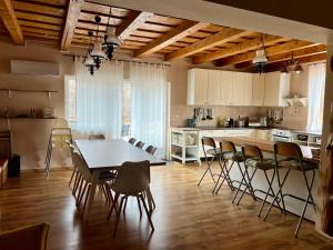 a kitchen and dining room with a table and chairs at Indawood in Mátraszentimre