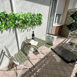 a table and chairs on a patio with a bottle of wine at Petlyapartments #Labrador in Bellaria-Igea Marina