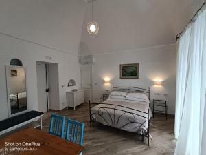 a bedroom with a bed and a table and chairs at Regina Margherita in Positano