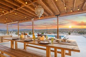 a dining room with a table with a view at Loma Vista By The Cohost Company in Sunfair Heights
