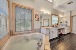 a large bathroom with a tub and a sink at Poconos Playtime Paradise Luxury Play Escape in Pocono Pines +61 photos