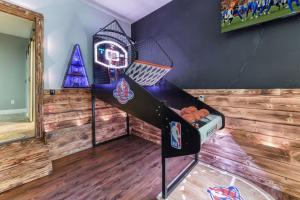 a room with a basketball hoop on the wall at Fun N Sun - Ultimate Backyard Pool And Game Room in Sevierville