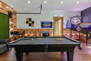 a billiard room with a pool table at Fun N Sun - Ultimate Backyard Pool And Game Room in Sevierville