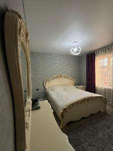 a bedroom with a large bed in a room at Bishkek Guest House in Bishkek