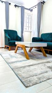 a living room with a coffee table and two couches at Spacious 2Bedroom Apartment Muyenga-Bukasa in Kampala