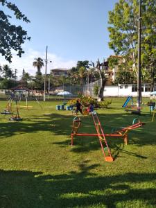 a park with children playing on swings at Saqua Meu Aconchego in Saquarema