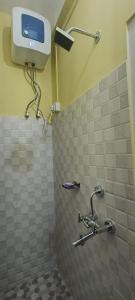 a bathroom with a tiled shower with a toilet at Green Tara Homestay in Dirang Dzong +19 photos