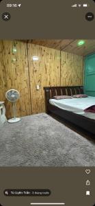 a room with two beds and a table in it at Rosie Homestay in Ha Giang