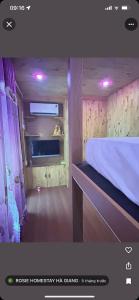 a bedroom with a bed with purple lights on it at Rosie Homestay in Ha Giang +2 photos
