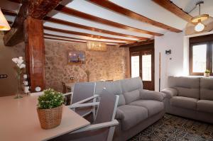 a living room with a couch and a table at La Casa El Cura in Campillo de Dueñas +56 photos